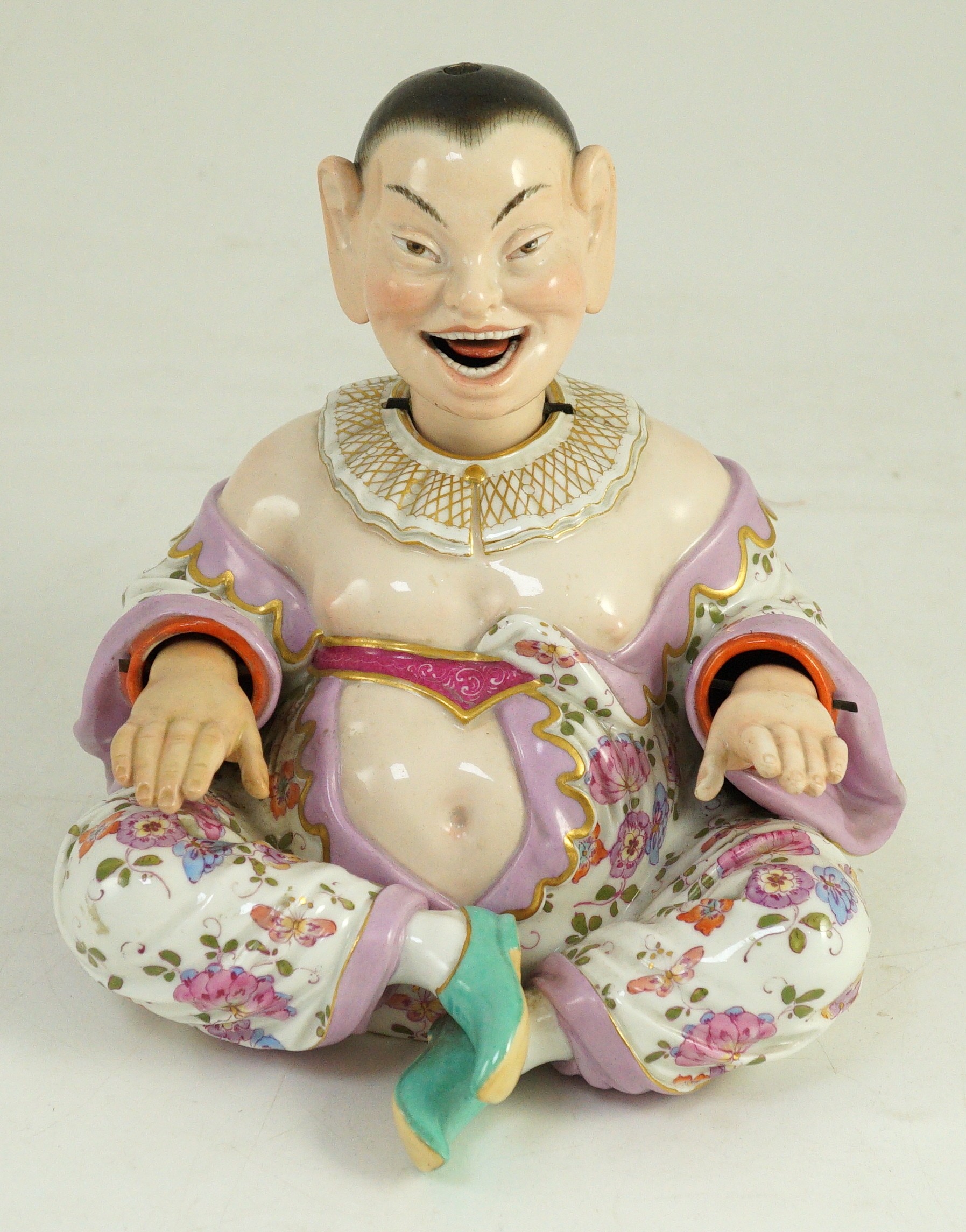 A Meissen figure of a nodding chinaman, 19th century, 17.5cm high, right hand restored